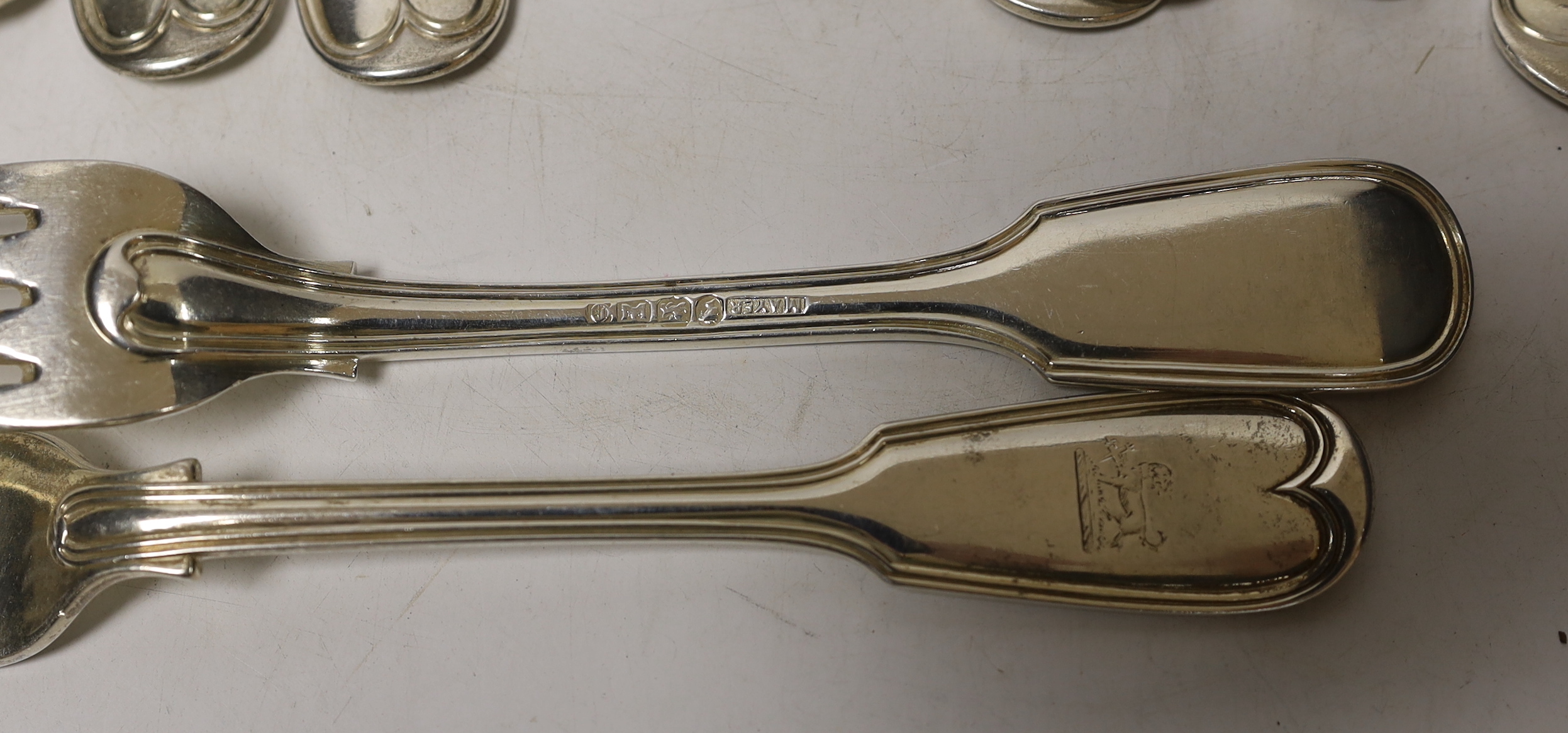A matched set of twelve 19th century silver fiddle and thread pattern table forks, various dates and makers, including Exeter, some hallmarks very rubbed, 36.1oz.